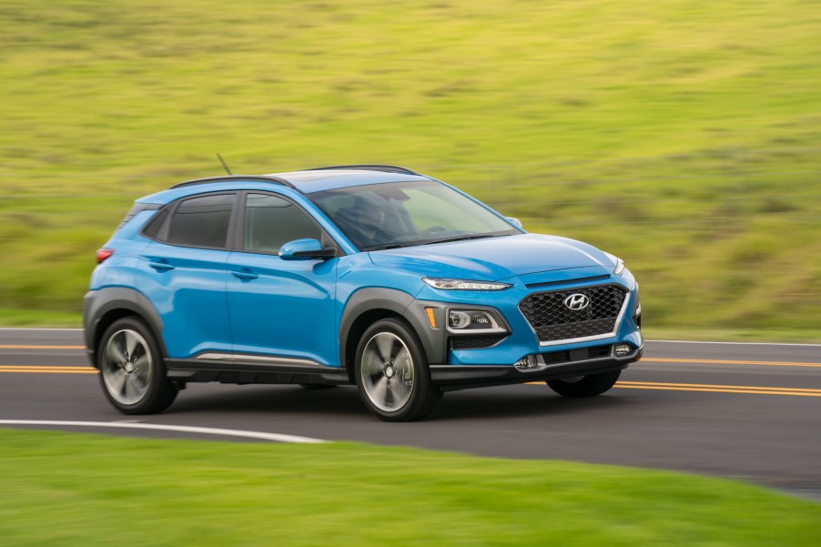 Hyundai Kona subcompact SUV driving on curvy country road