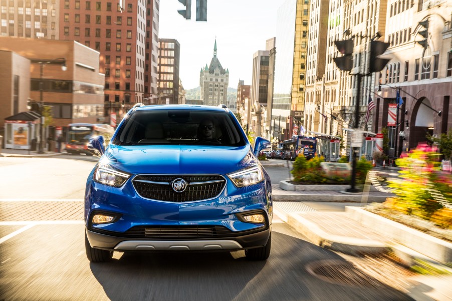 Electric Buick Encore driving through city streets.