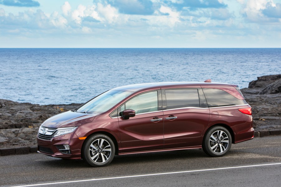 burgundy 2020 Honda Odyssey driving along a shoreside roadway