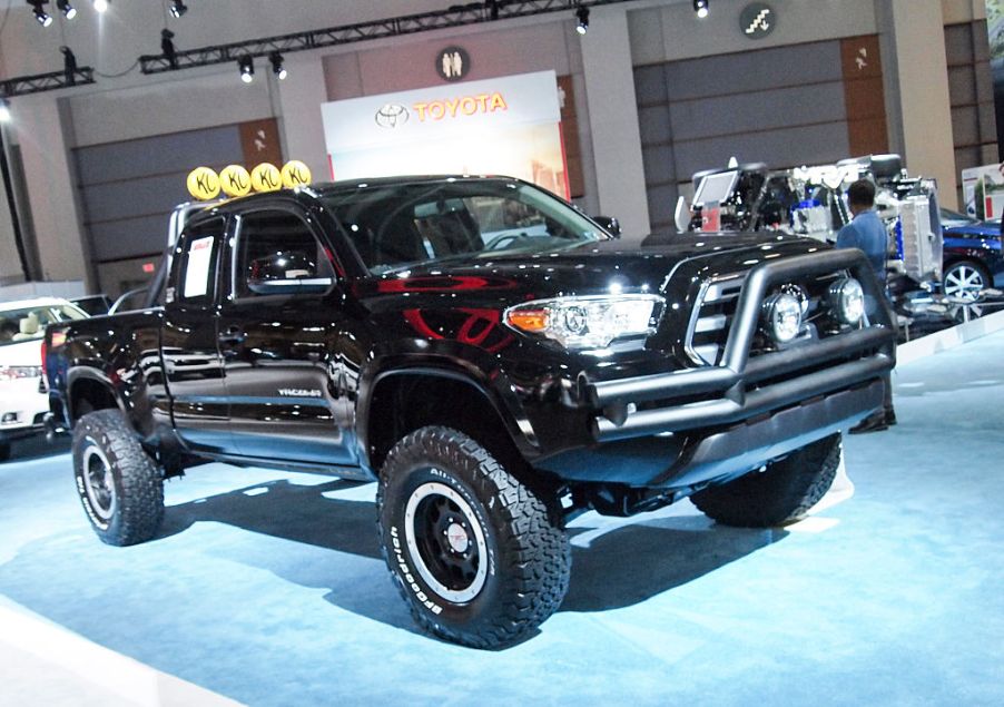 A modded Toyota Tacoma at a car show.