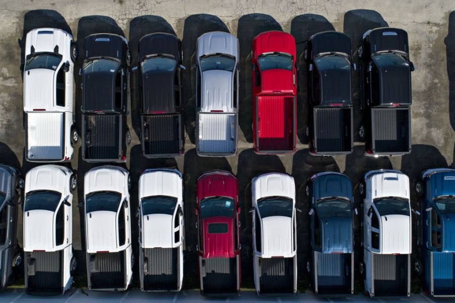 Chevrolet Silverado trucks are displayed at a car dealership