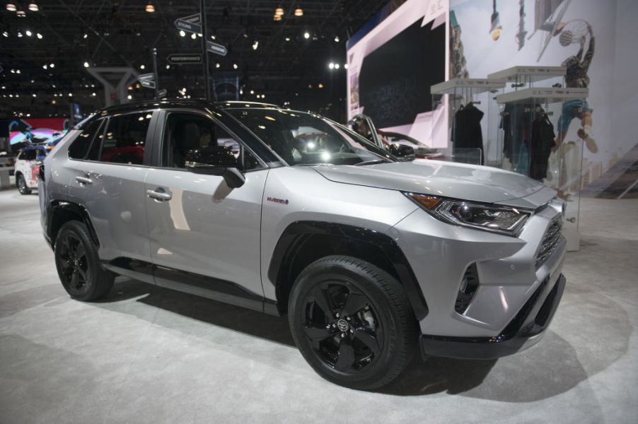 A silver Toyota RAV4 on display at an auto show.