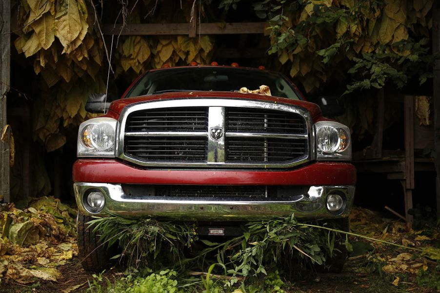 A Dodge Ram pickup truck sits parked inside a barn