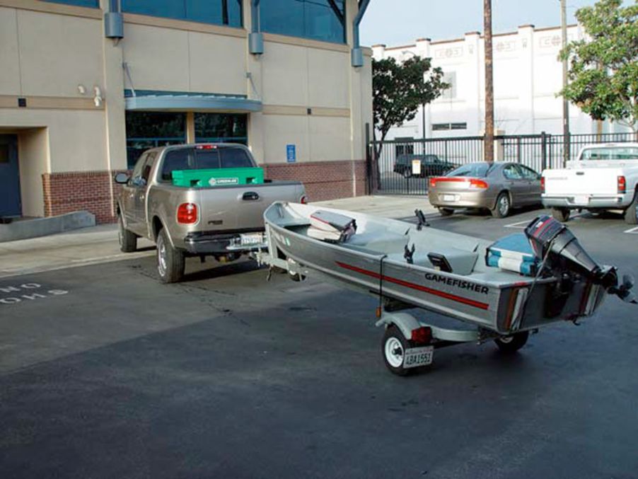 A Ford F-150 towing a small boat.