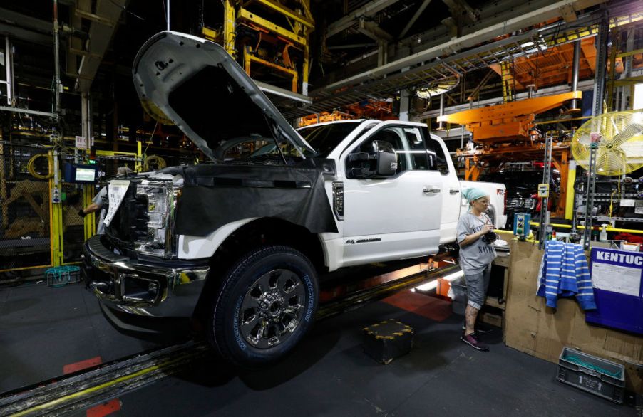 A worker builds a Ford F-250 as it goes through the assembly line at the Ford Kentucky Truck Plant