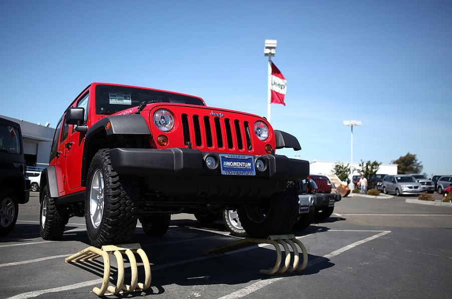 A used Jeep Wrangler for sale at a car dealership.