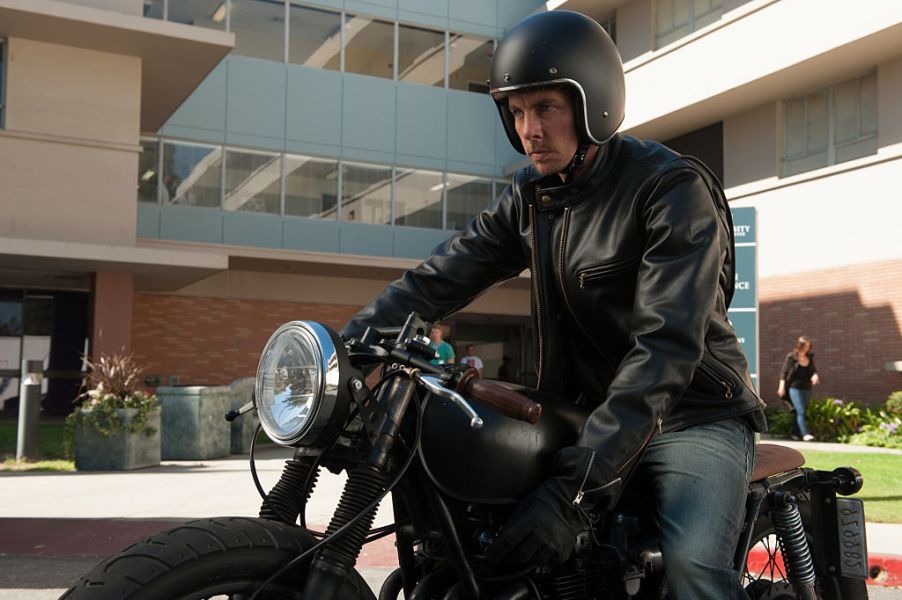 Dax Shepard sitting on a motorcycle ready to ride