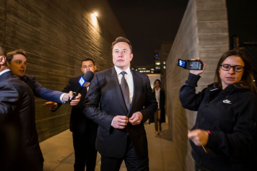 Tesla co-founder Elon Musk walking out to the media.