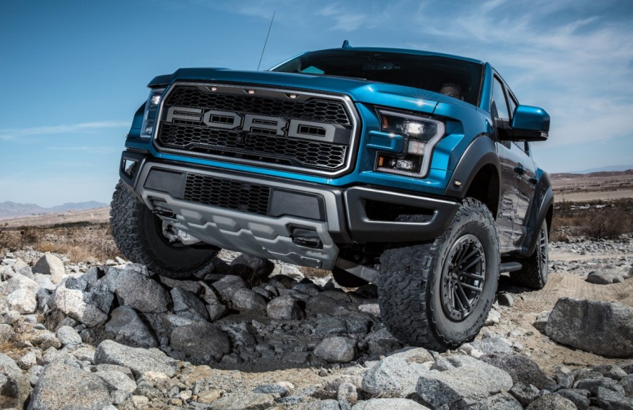 Ford F-150 Raptor climbing over rocks