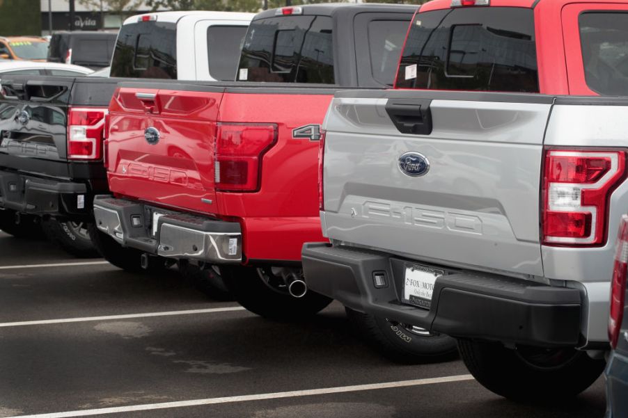 Ford F-150 full-size trucks on a sales lot.