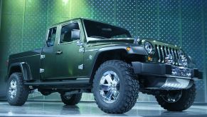 A green Jeep Gladiator on display at an auto show