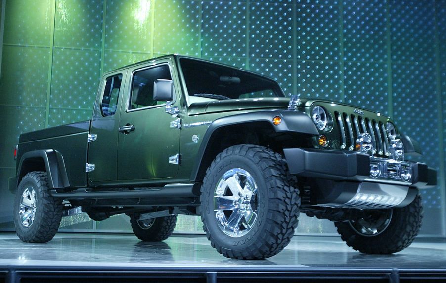 A green Jeep Gladiator on display at an auto show