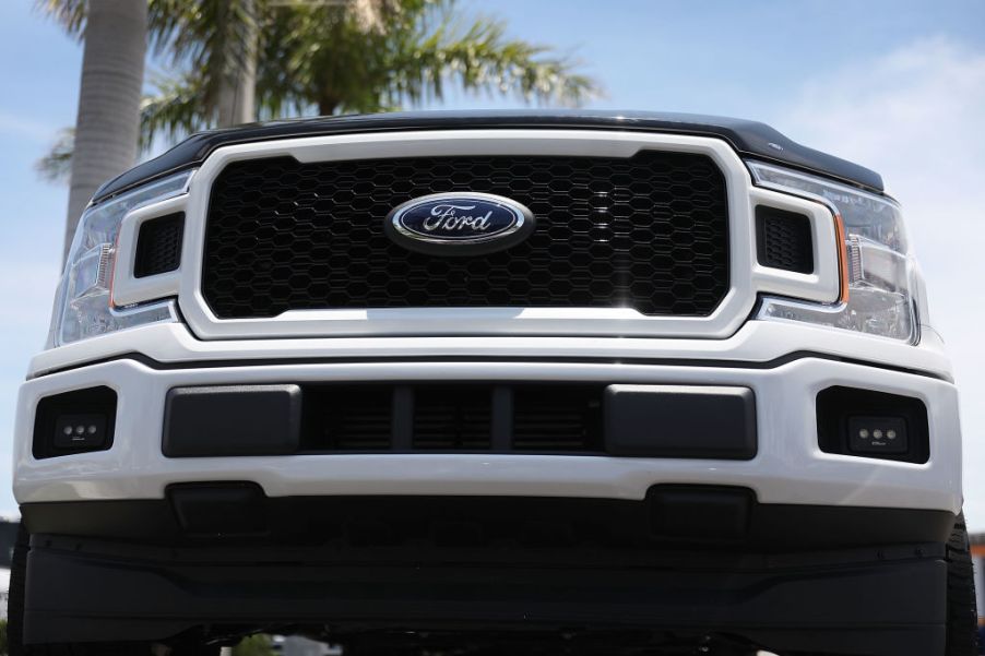 Ford F-150 models on a sales lot at a dealership