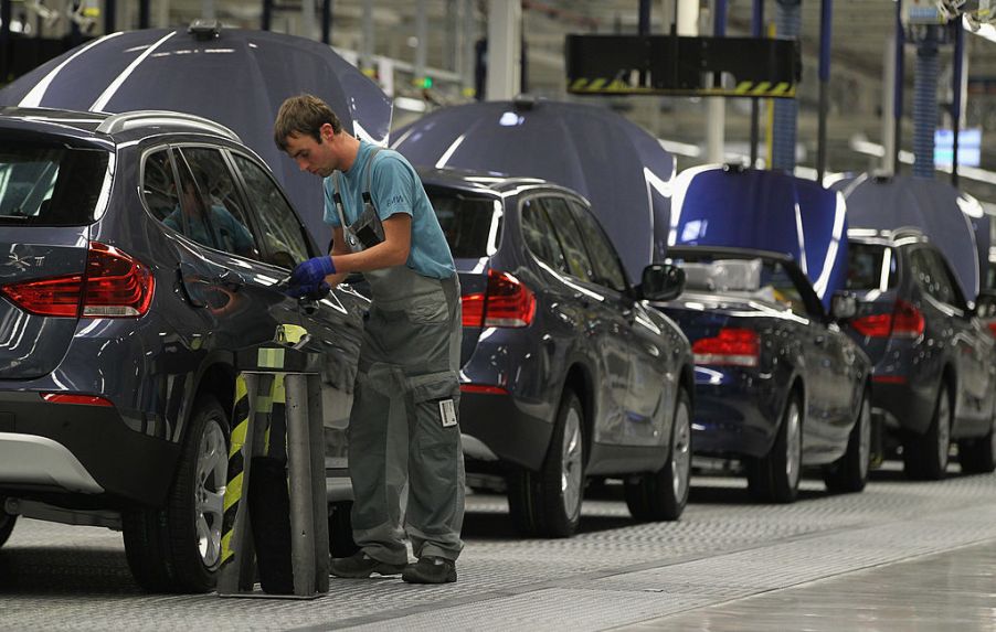 German workers assemble BMW cars at a factory