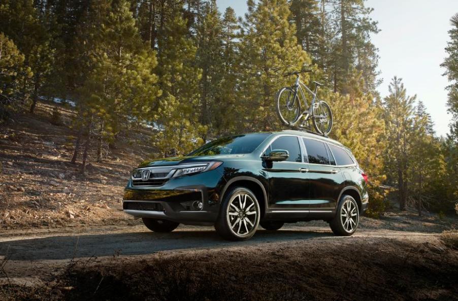 The 2020 Honda Pilot driving down the countryside.