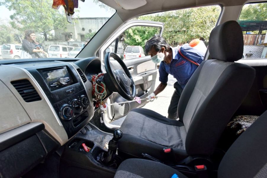 DTC cleaning staff chemically disinfect and sanitize a taxi as a precautionary measure in view of coronavirus concerns