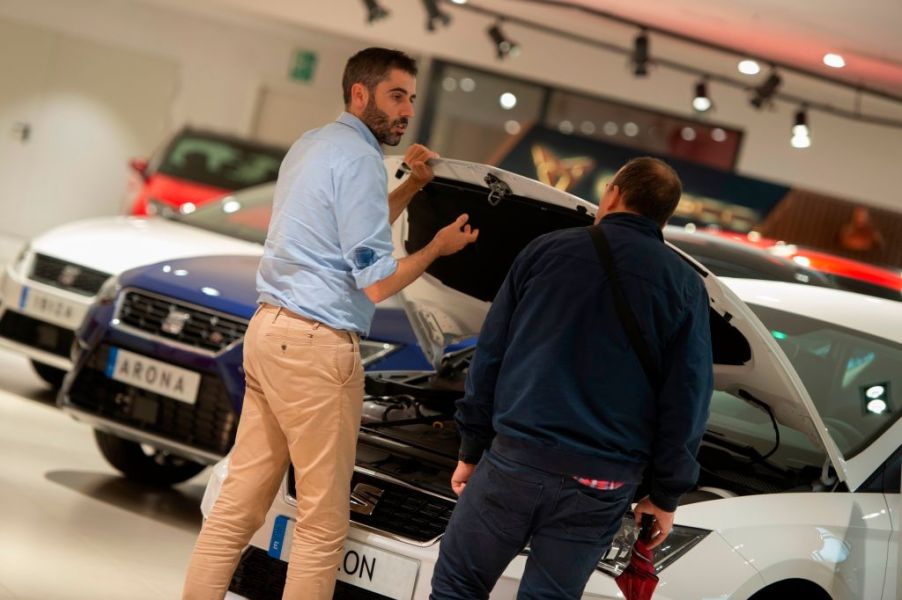 A car salesman showing a customer around