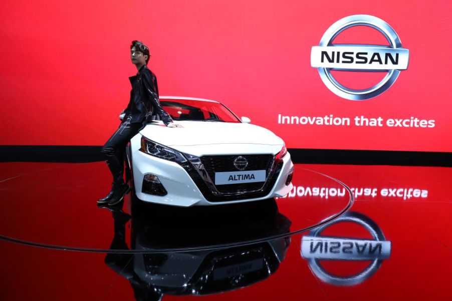 A model poses next to a NISSAN Altima at the Seoul Motor Show 2019