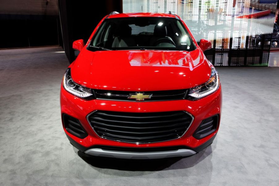 A red Chevy Trax on display at an auto show