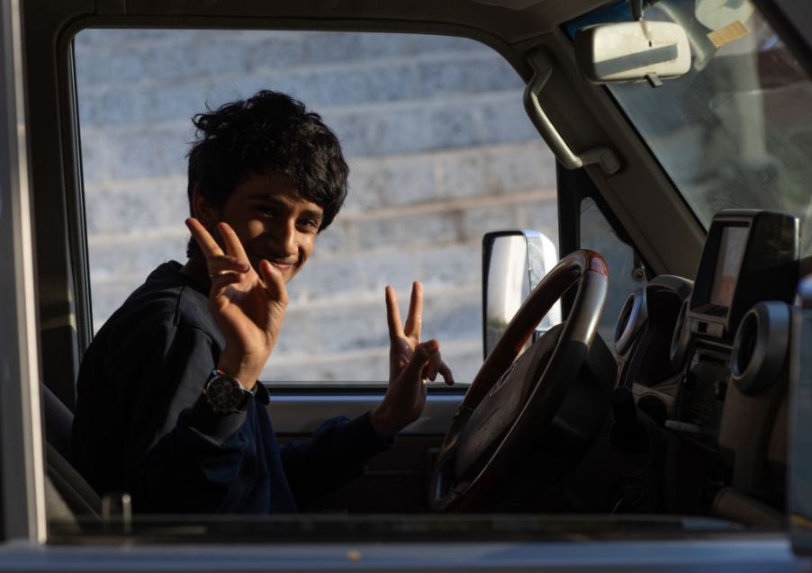 Teenage boy driving a car