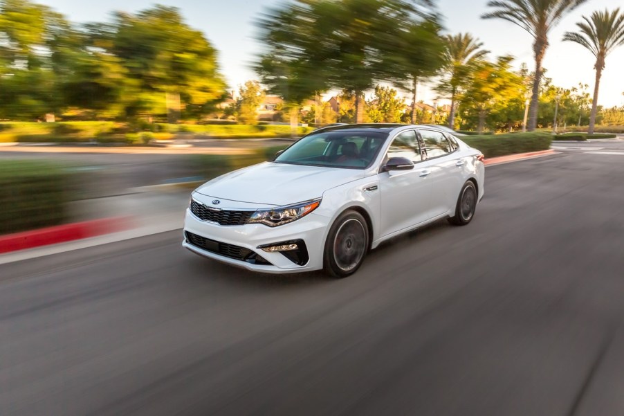 a white 2020 Kia Optima at speed on the road