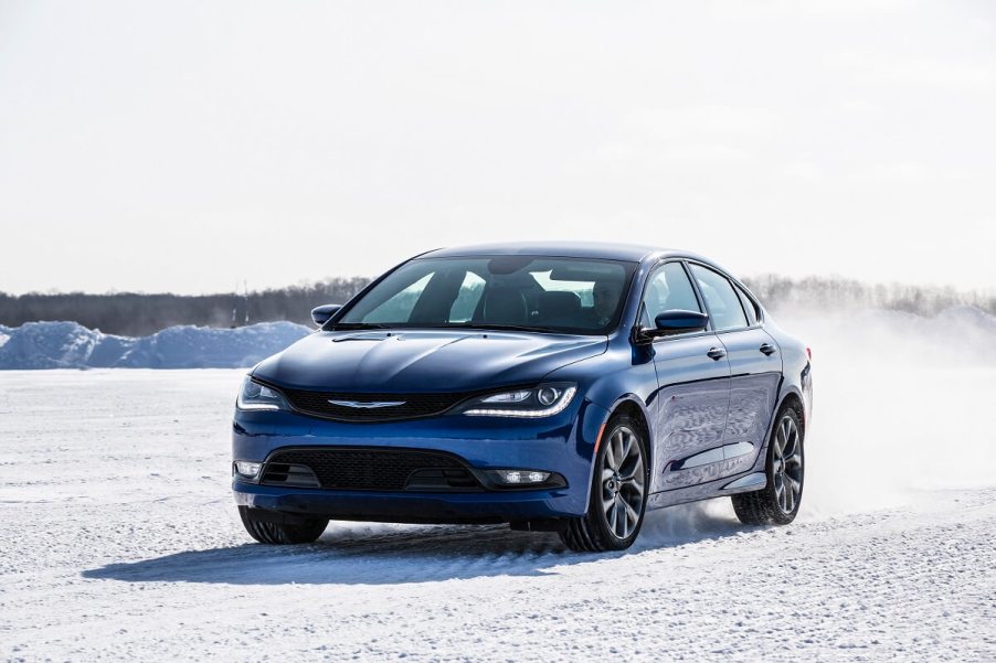 A blue 2015 Chrysler 200 AWD kicks up snow.