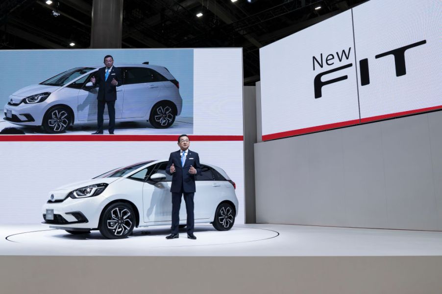 Honda Motor Co. President Takahiro Hachigo speaks in front of the company's redesigned Fit compact vehicle during a press conference at the Tokyo Motor Show