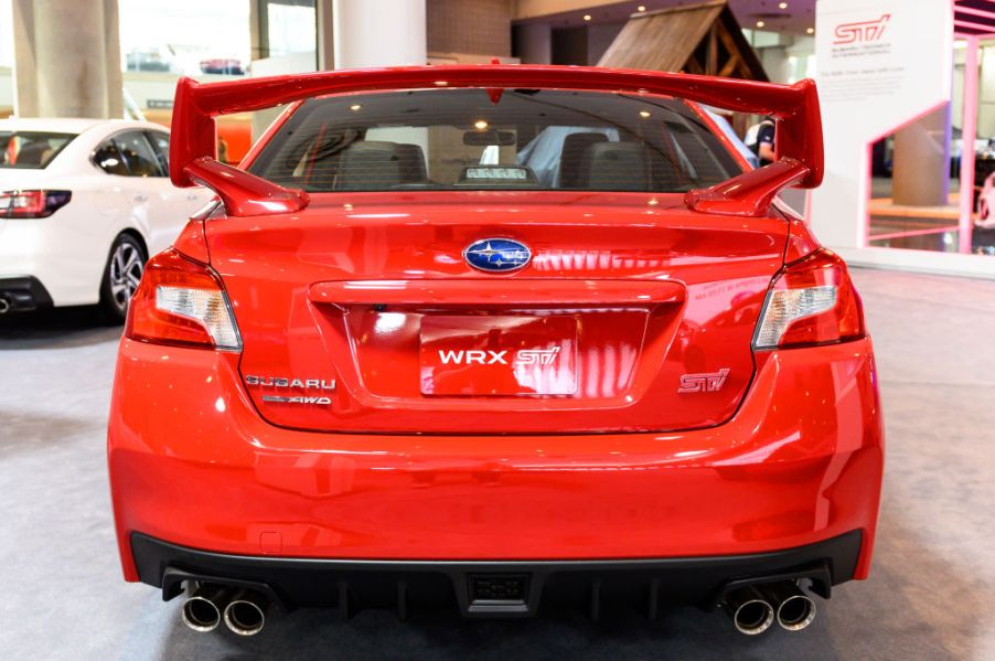 A red Subaru WRX STI on display at an auto show