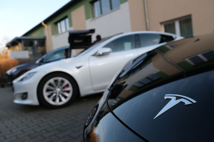 Electric cars of US automaker Tesla stand outside the Hangelsberg community center