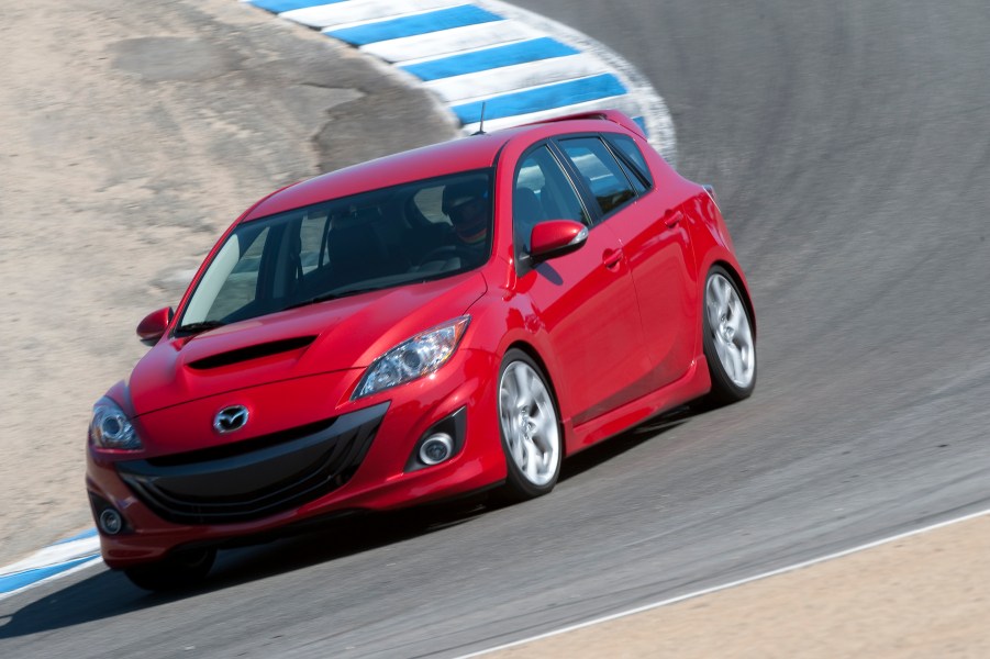 Red 2010 Mazdaspeed3 going around a corner