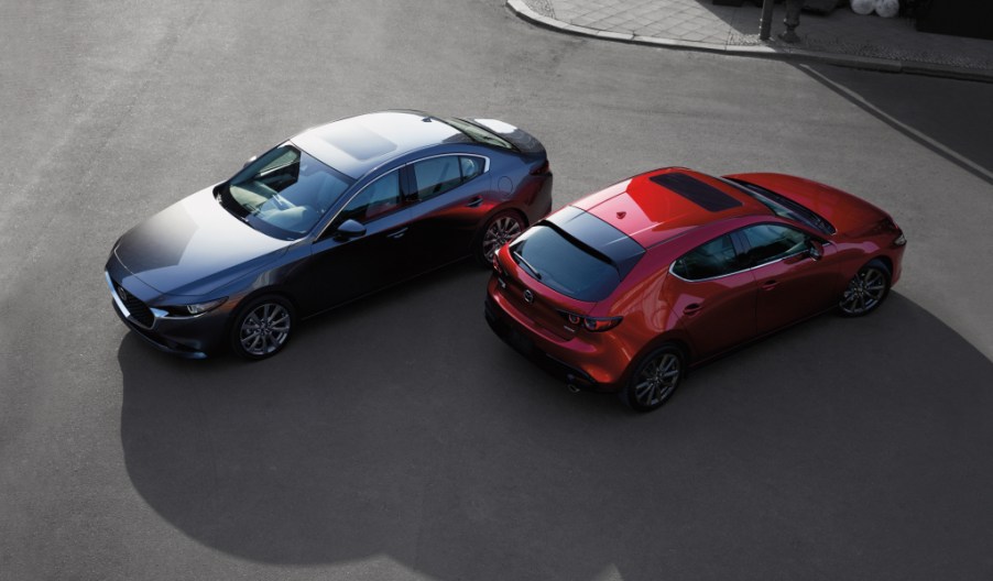 a gray sedan and a red hatchback from a sky view