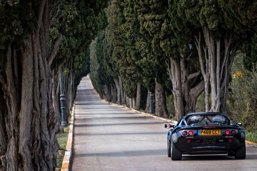 1 1997 Lotus Elise Sport 190 driving on a beautiful country road