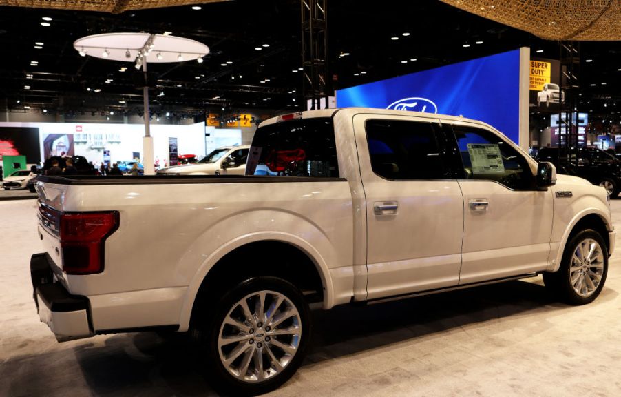 A white Ford F-150 on display at an auto show