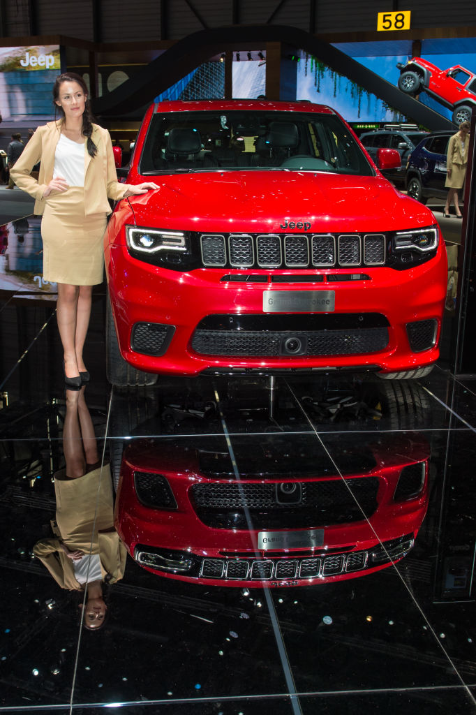 Model poses in front of Jeep Grand Cherokee at the 88th Geneva International Motor Show