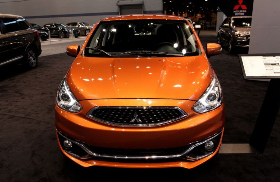 An orange Mitsubishi Mirage on display at an auto show