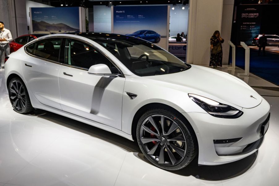 Tesla Model 3 compact sedan car in white on display at Brussels Expo