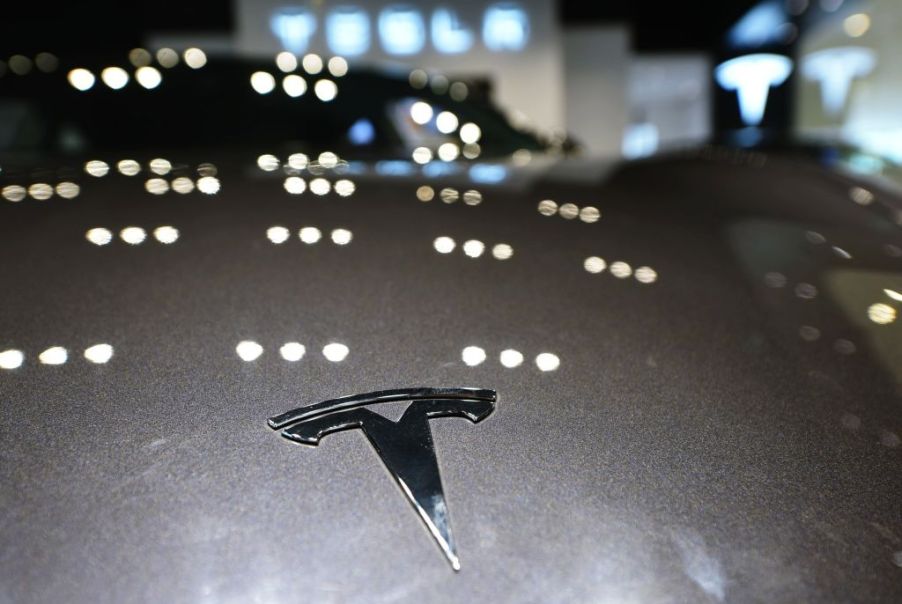 A Tesla logo is seen on a vehicle at a Tesla store