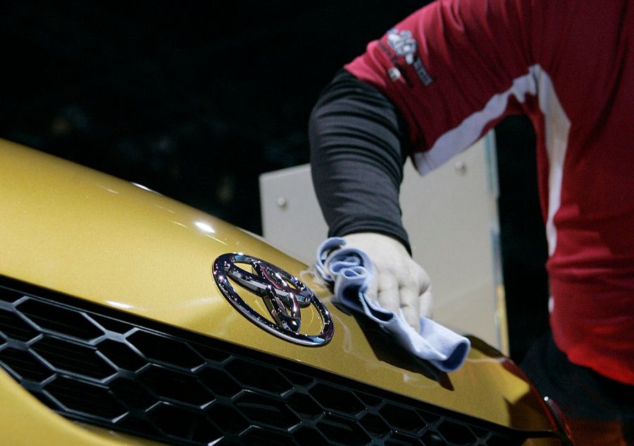 A worker polishes the hood of a Toyota Matrix during the first Media preview day at the Chicago Auto Show