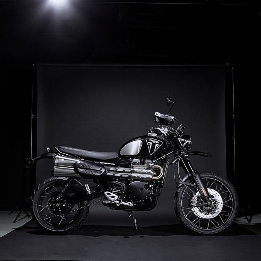 Black Triumph Scrambler 1200 Bond Edition, with 007 badge, blacked-out components, and brushed-foil knee pad