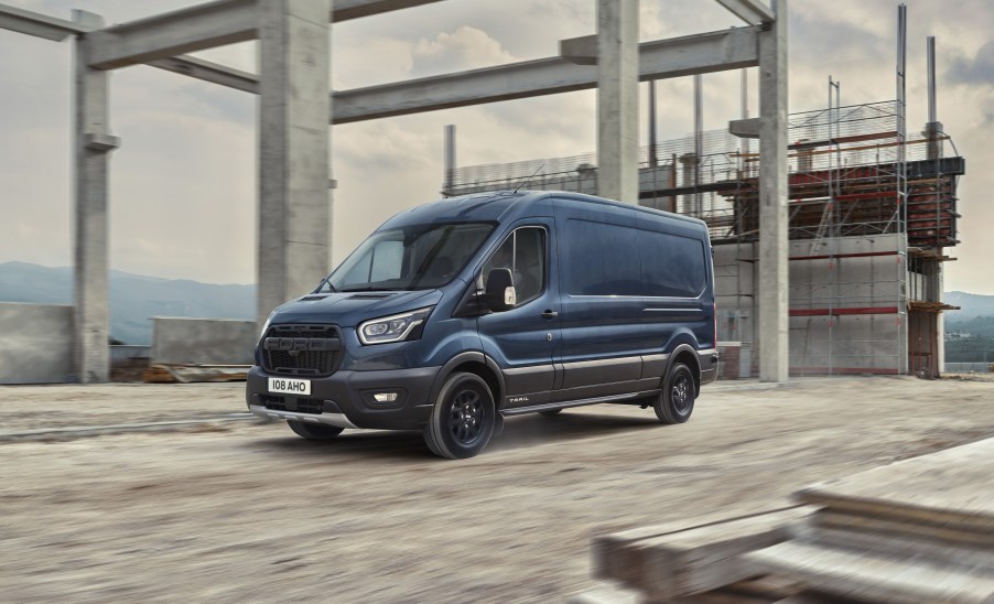 Blue 2020 Ford Transit Trail van driving through a construction site