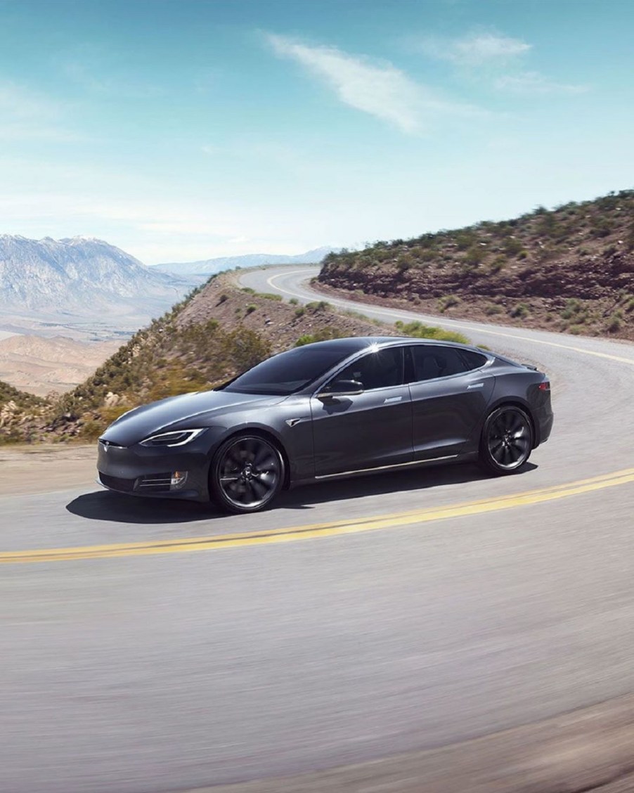 Metallic gray 2020 Tesla Model S Long Range Plus driving around a mountain road