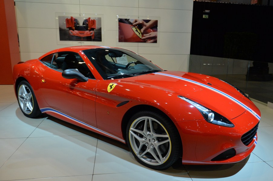 A red Ferrari California T sits on display at a car show