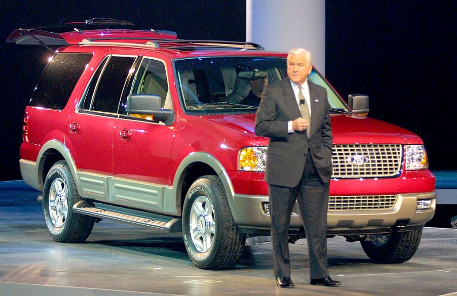 A man introducing a 2003 Ford Expedition on stage