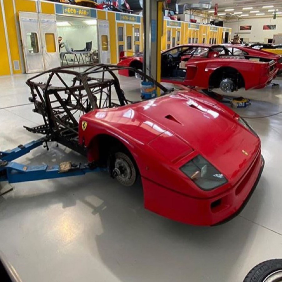 Red burned-out Ferrari F40 awaiting restoration in a shop