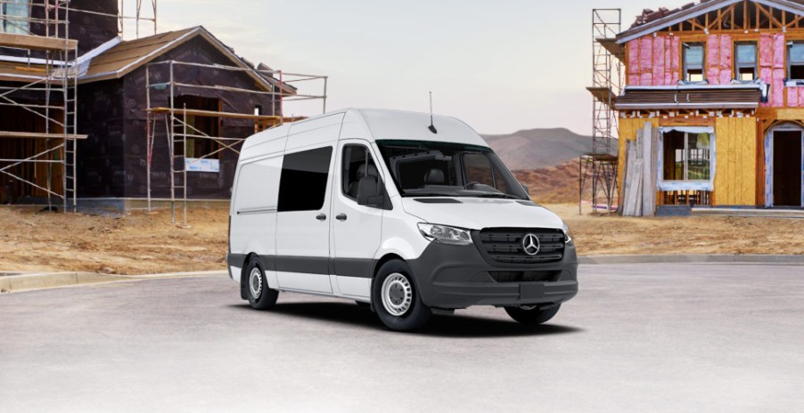 A white sprinter full-size cargo van on a construction site