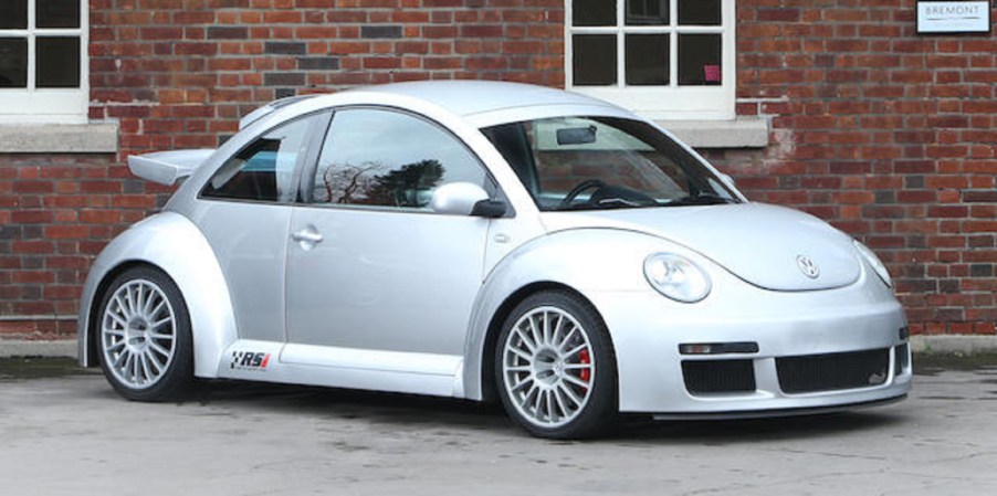 A silver 2001 Volkswagen Beetle RSI in front of a red-brick building