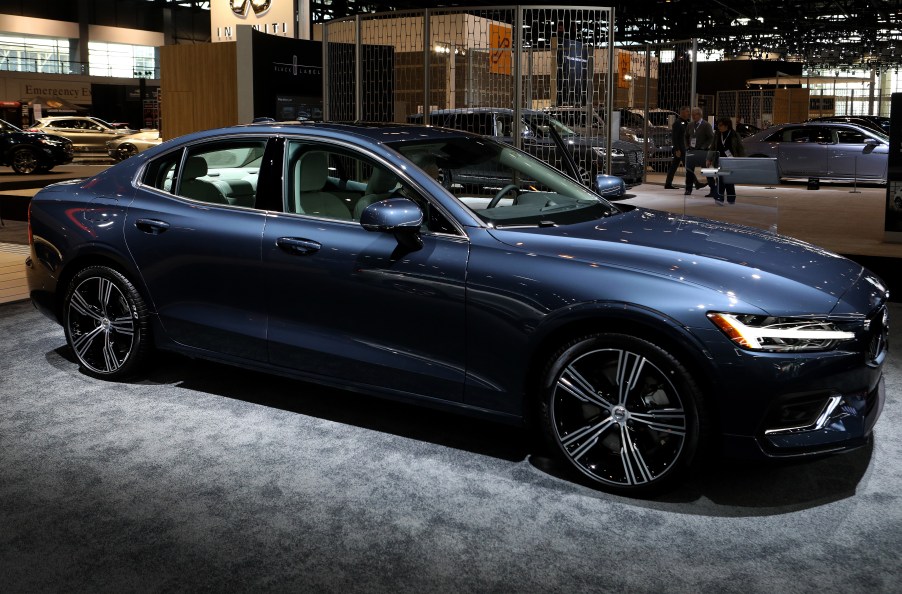 A blue 2019 Volvo S60 sits on display at a car show.