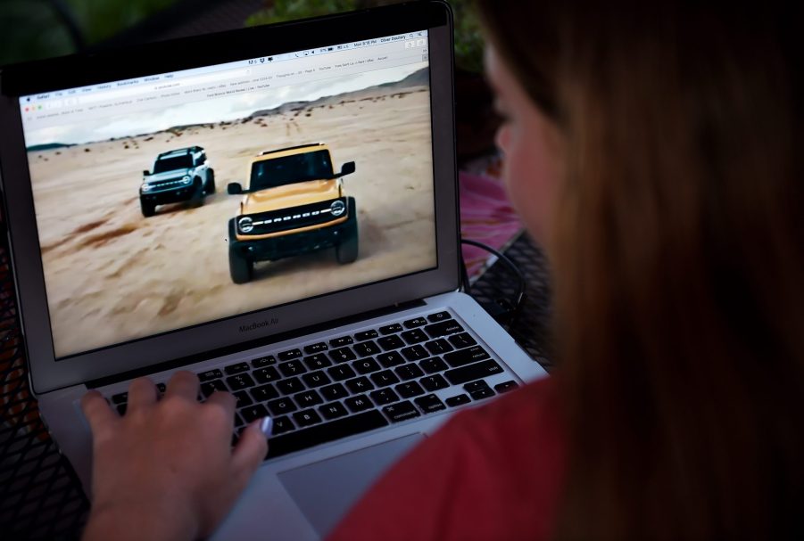 A woman checking out the new 2021 Ford Bronco on her laptop