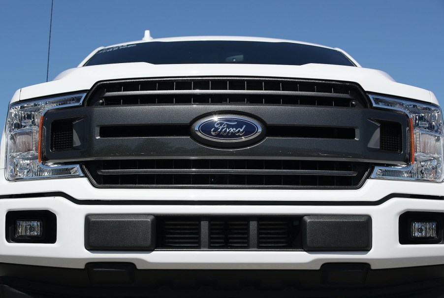 The front grill of a white Ford F-150 pickup truck is seen on Metro Ford's sales lot