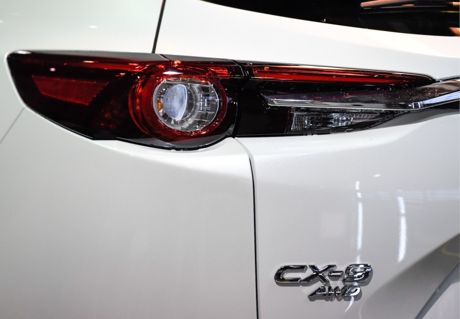 A white Mazda CX-9's rear badge